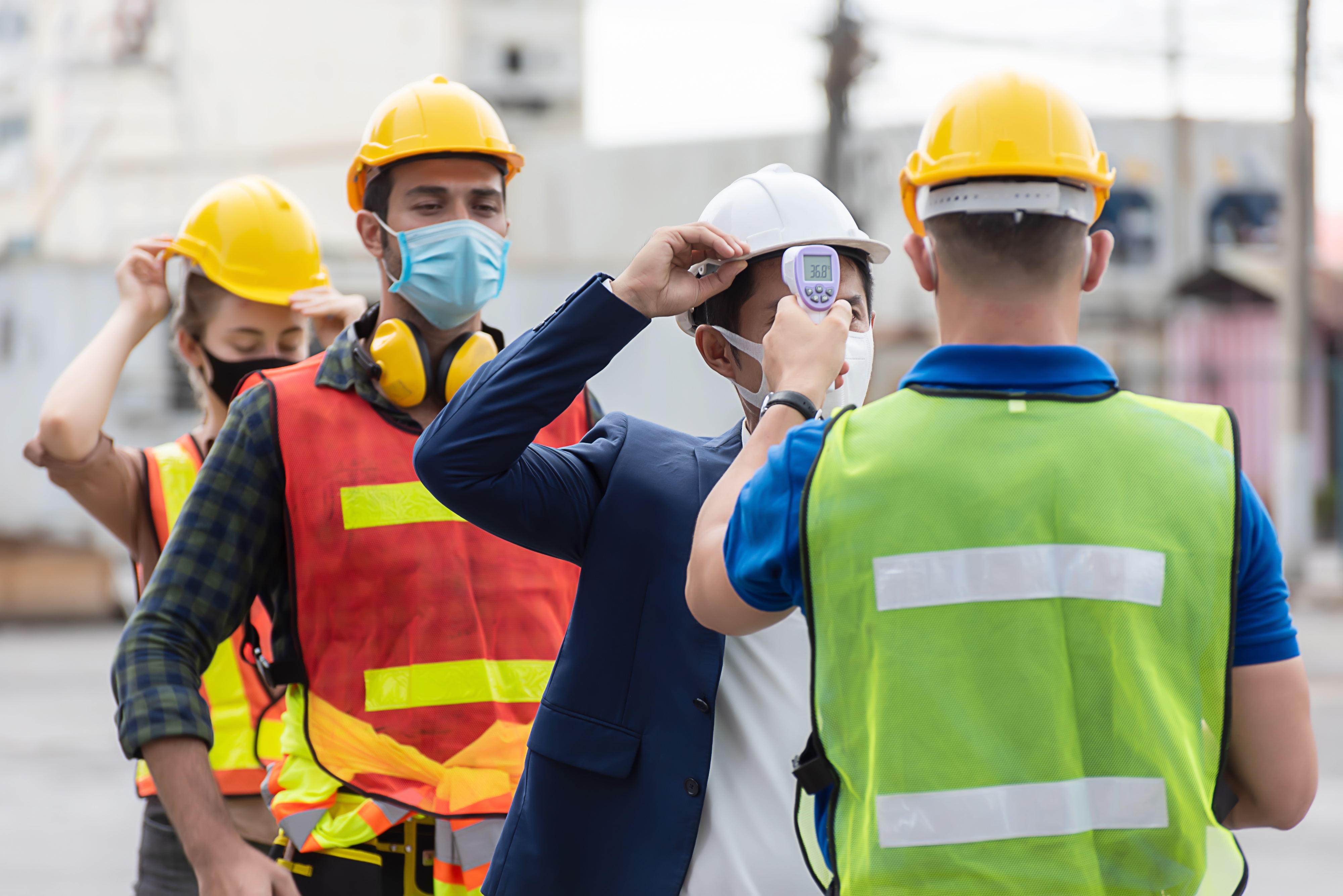 construction workers getting temperature taken