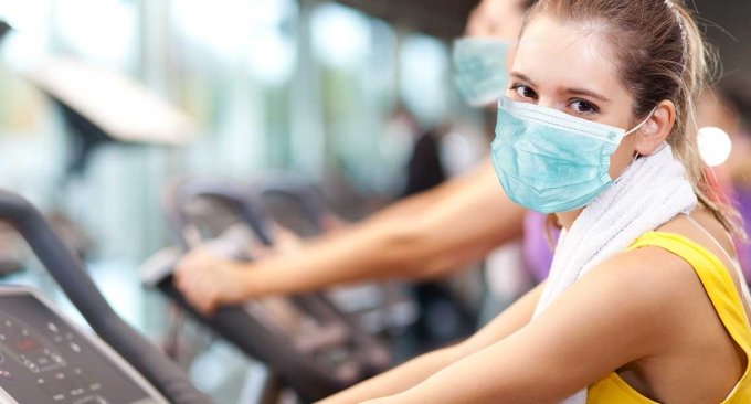 woman exercising with a mask on woman exercising with a mask on